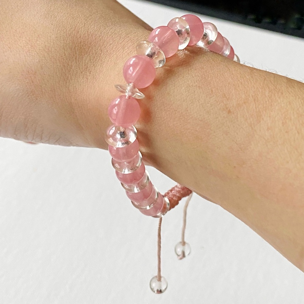 Pink and clear glass beaded cord bracelet.